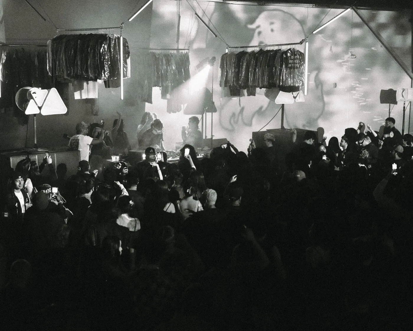 Black-and-white shot of the densely packed crowd with hands raised