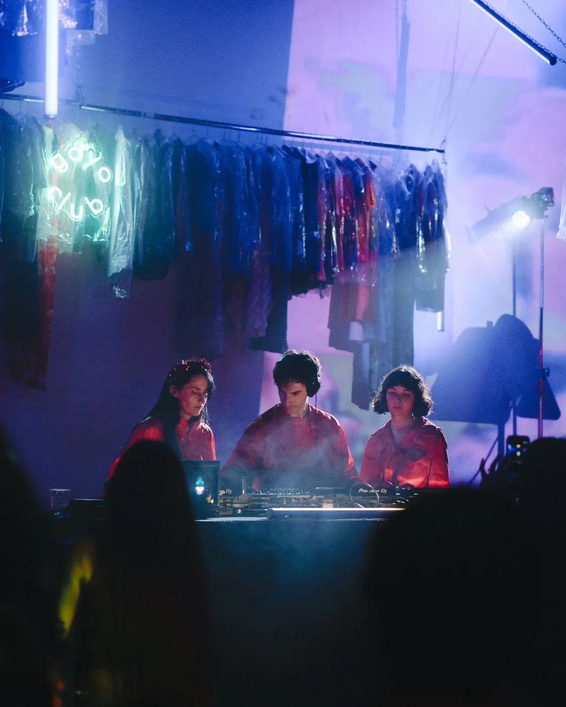 Wide shot of the trio DJ set with the crowd gathered in front