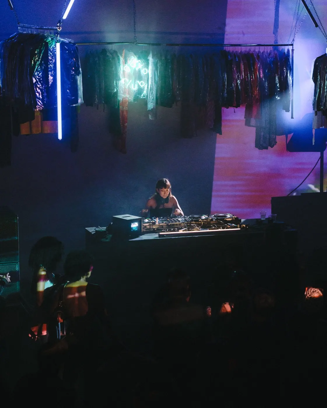DJ pointing and gesturing energetically toward the crowd