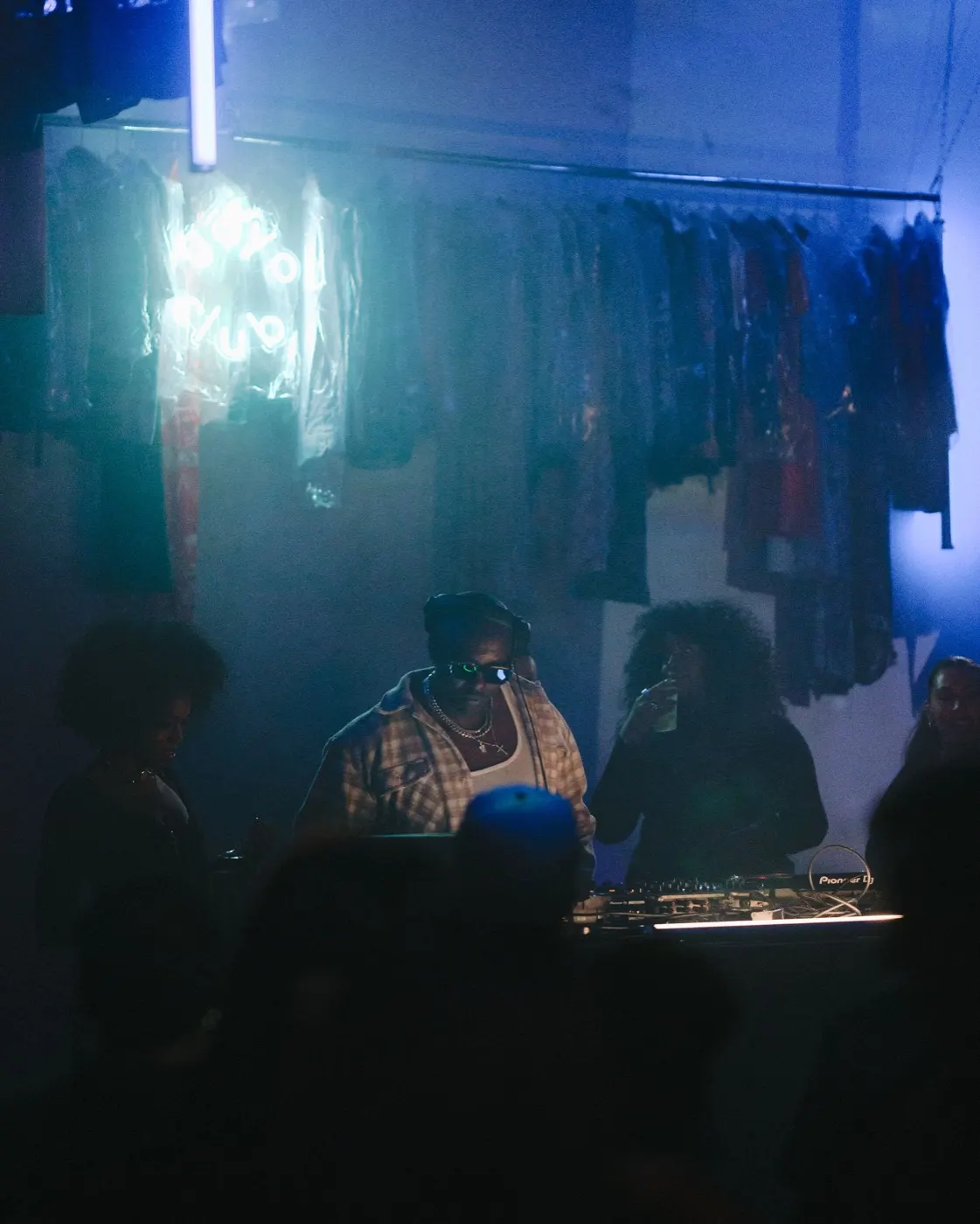 Two DJs sharing a close candid moment at the booth