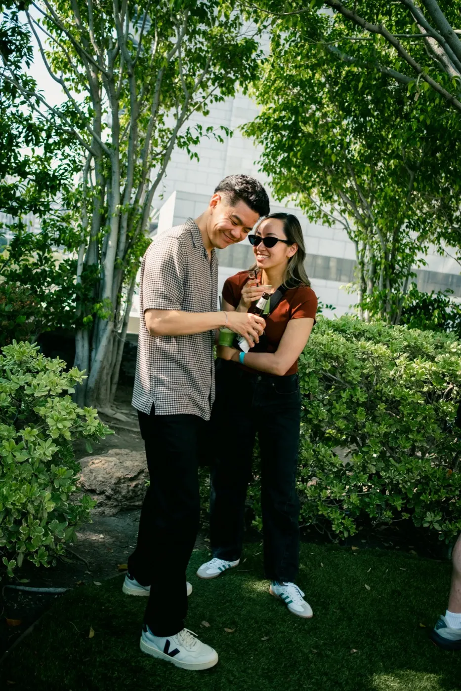 A couple laughing together while sharing a drink
