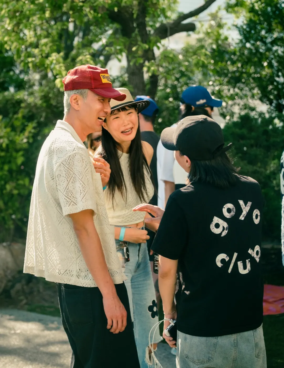 Guests talking, one wearing a jacket with the goyo club logo