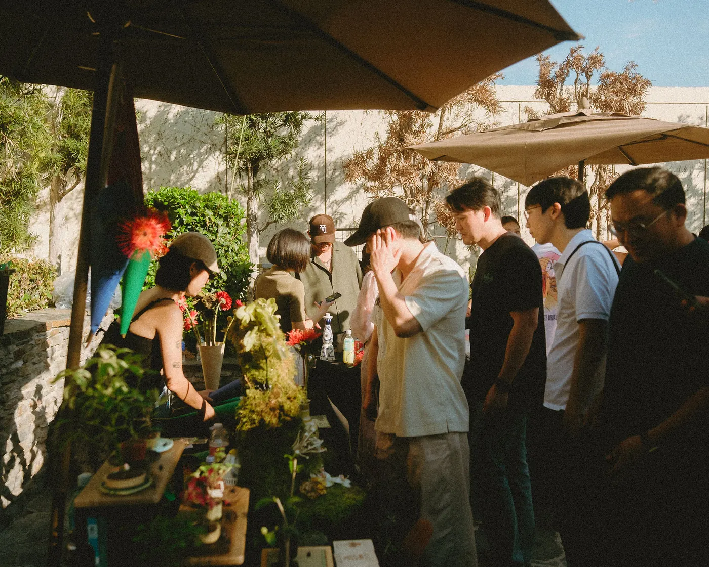 Guests browsing the flower and goods vendor