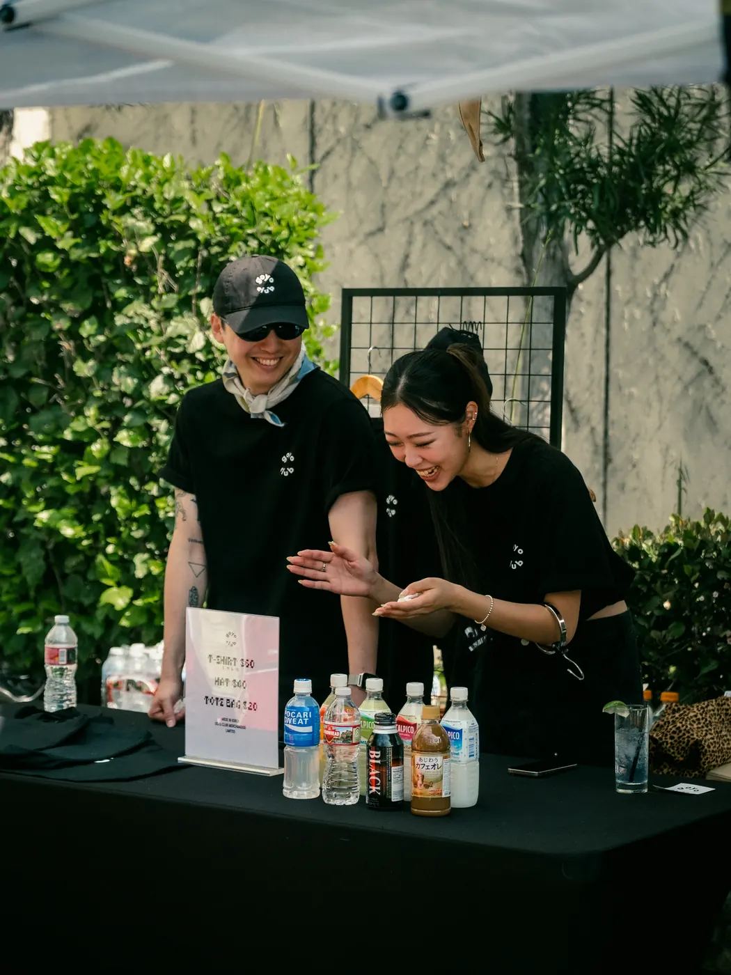 Vendors pouring drinks at the beverage table