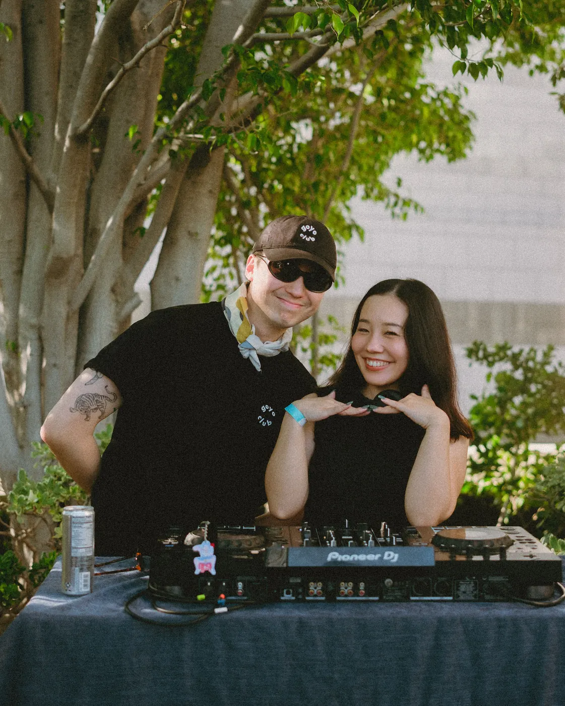 Guests posing behind the DJ booth
