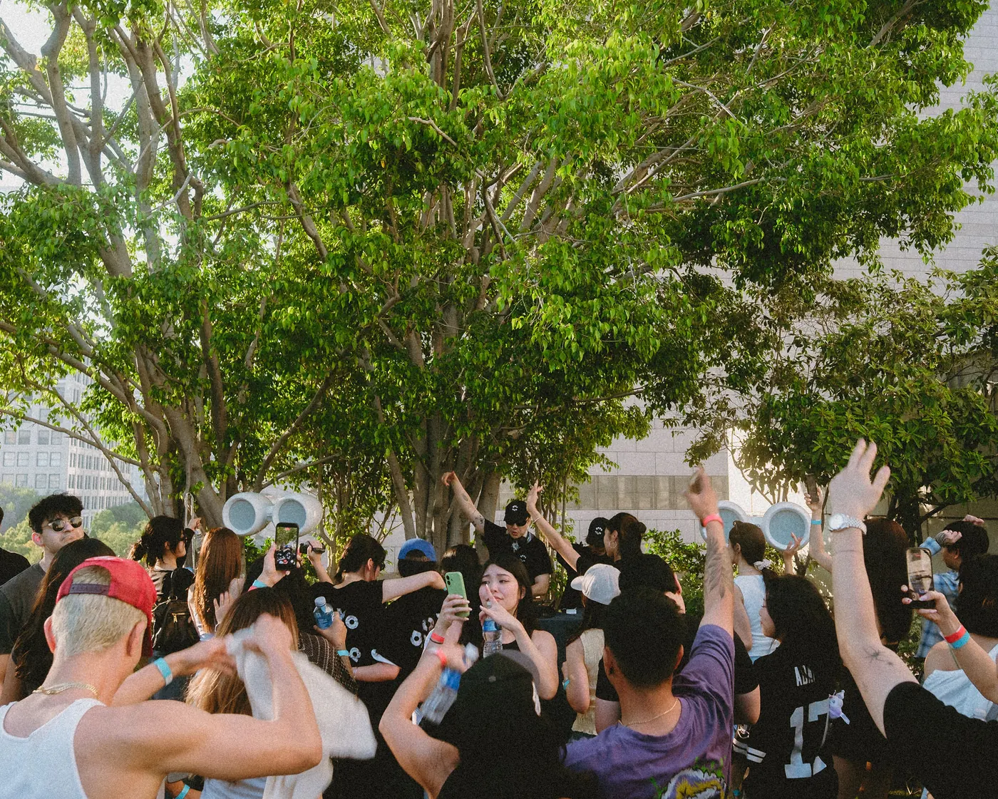 Crowd with hands in the air in front of the booth