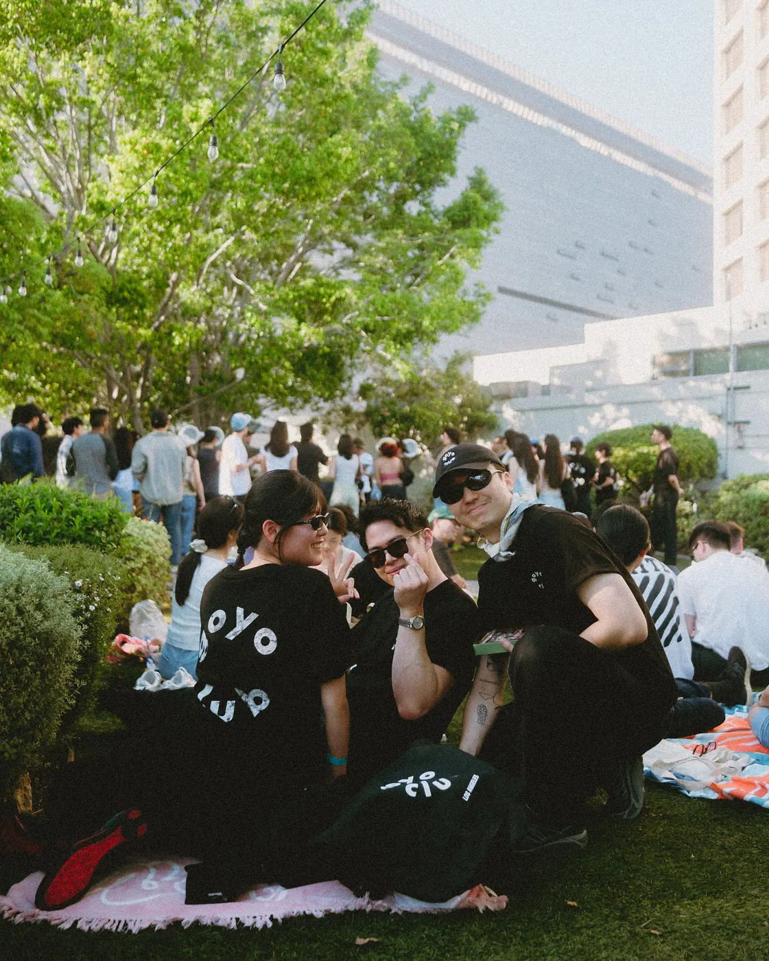 Guests in goyo club tees picnicking on the lawn