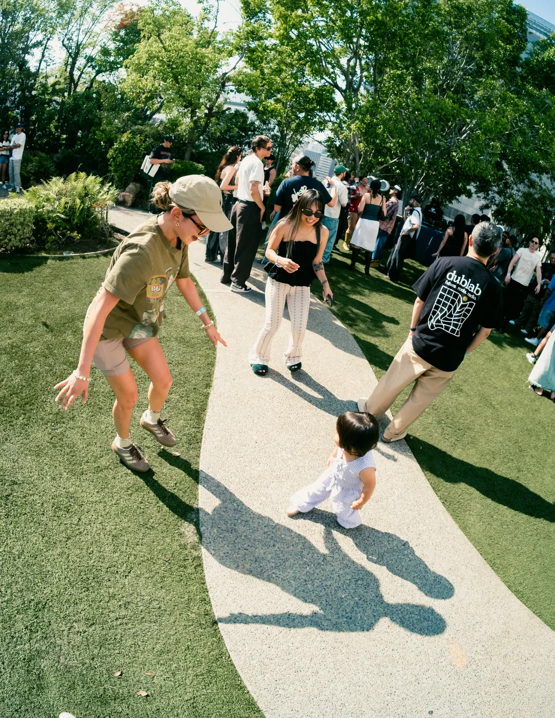 A guest walking a small child along the garden path