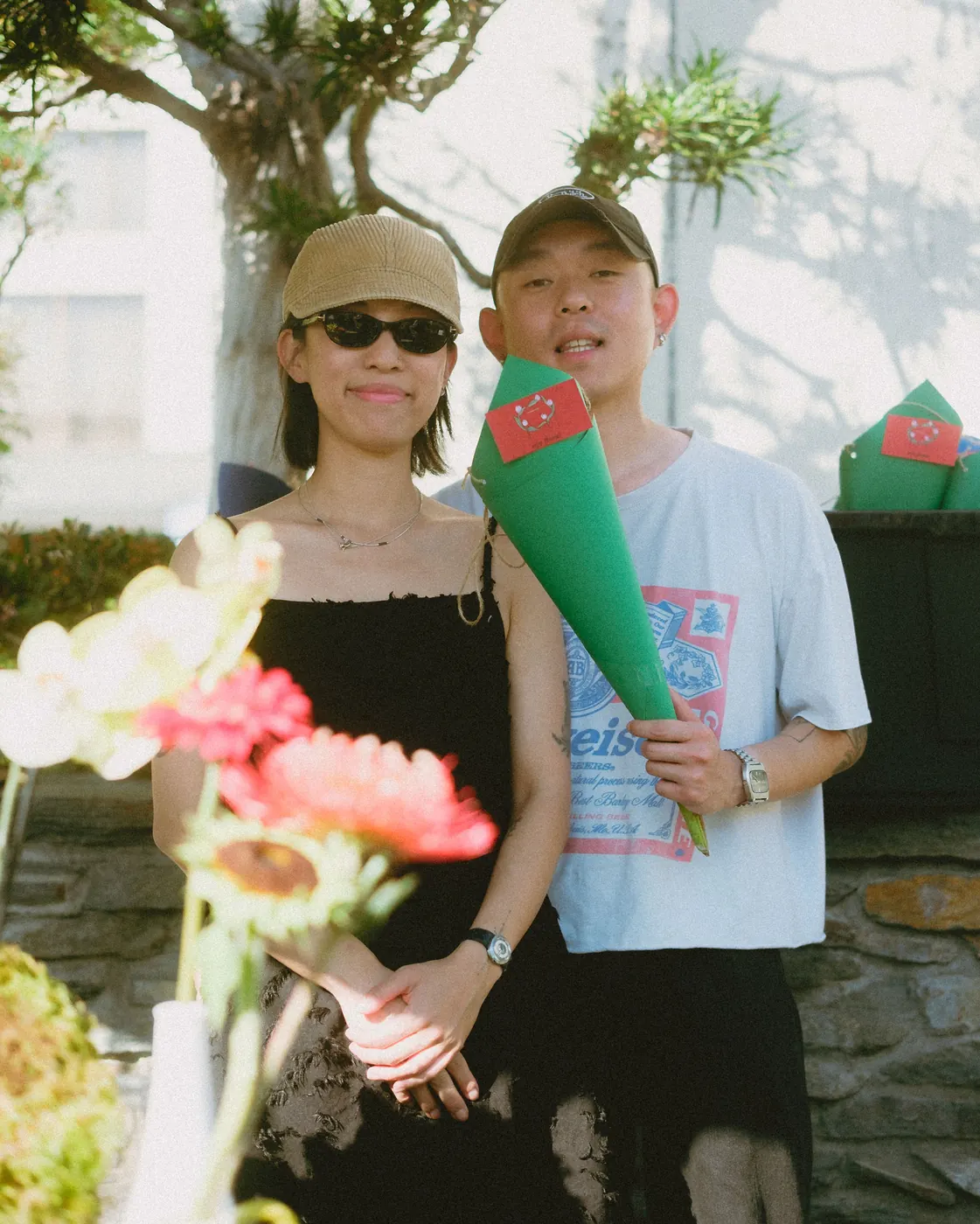 Two guests posing with bouquets